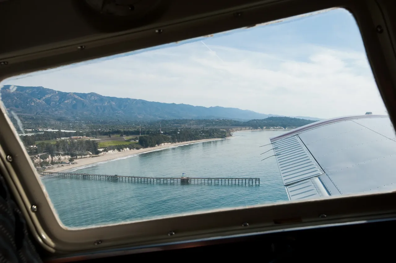 The Santa Barbara coastline and Stearns Wharf seen through an airplane window