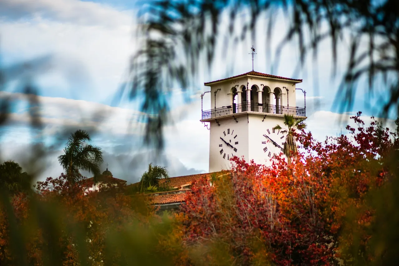 The Santa Barbara County Courthouse clock tower framed by autumn leaves
