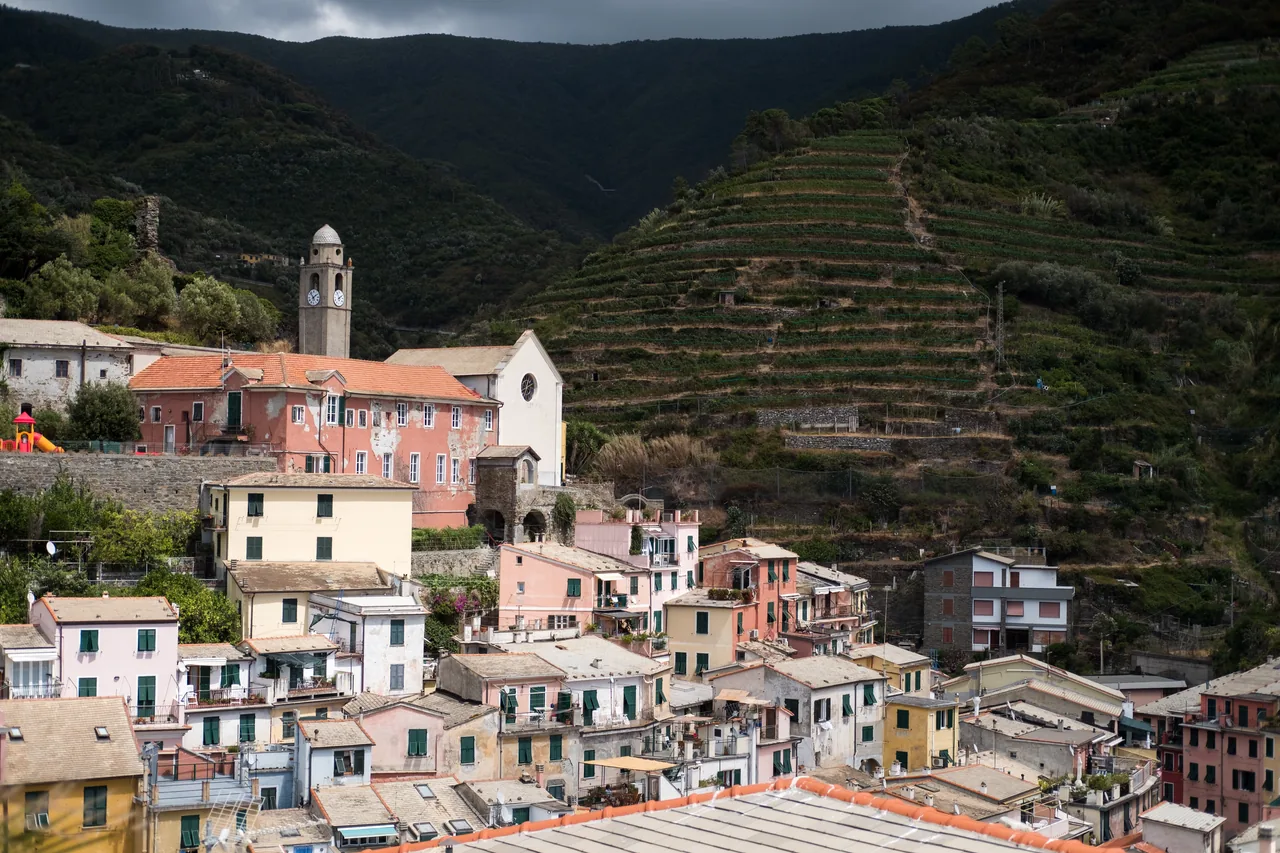 A hillside village beneath terraced hills